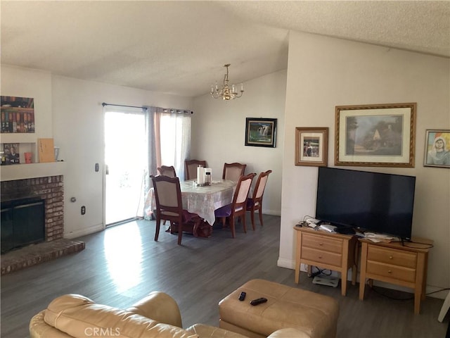 13489 Buggy Whip Ct, Victorville, CA 92392 - living area featuring a chandelier, wood finished floors, lofted ceiling, and a fireplace