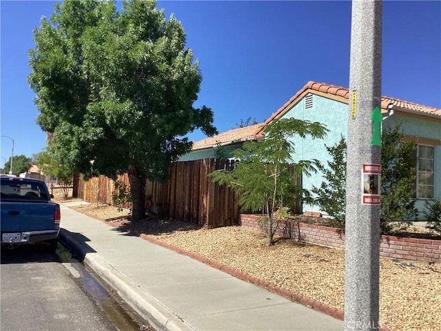 13489 Buggy Whip Ct, Victorville, CA 92392 - view of side of home featuring a tile roof and stucco siding