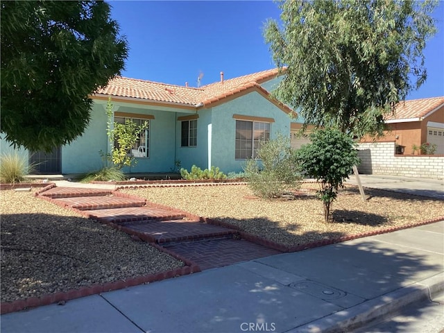13489 Buggy Whip Ct, Victorville, CA 92392 - view of front of home featuring a tiled roof and stucco siding