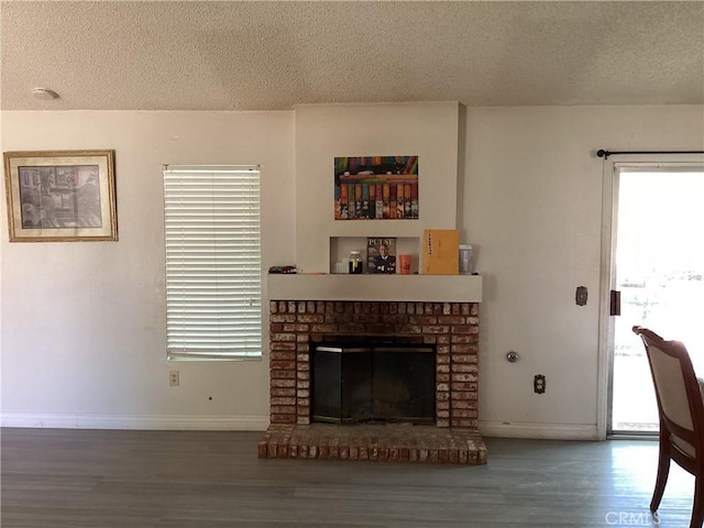 13489 Buggy Whip Ct, Victorville, CA 92392 - living area with a textured ceiling, wood finished floors, and a brick fireplace