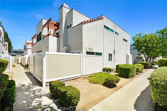 20290 E Arrow Unit C, Covina, CA 91724 - view of home's exterior featuring stucco siding, a residential view, and a chimney