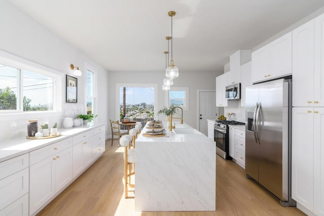 7284 W Point Ave, La Mesa, CA 91942 - kitchen featuring stainless steel appliances, light wood-type flooring, and white cabinetry