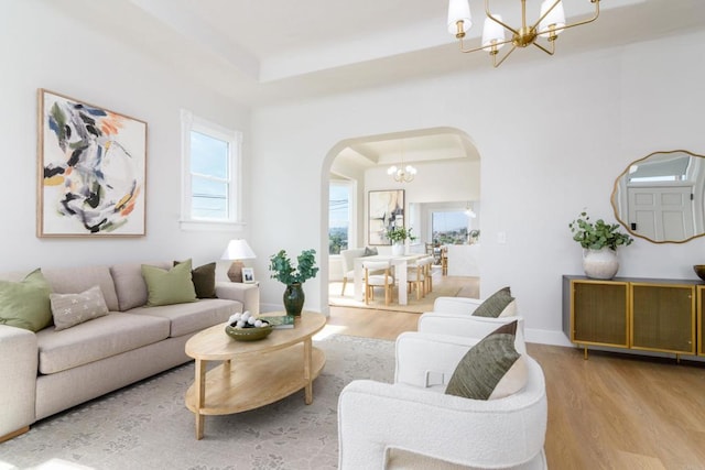 7284 W Point Ave, La Mesa, CA 91942 - living area with arched walkways, a chandelier, wood finished floors, and a raised ceiling