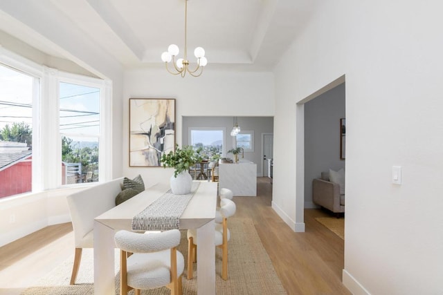 7284 W Point Ave, La Mesa, CA 91942 - dining space featuring light wood-style flooring, a chandelier, and a raised ceiling