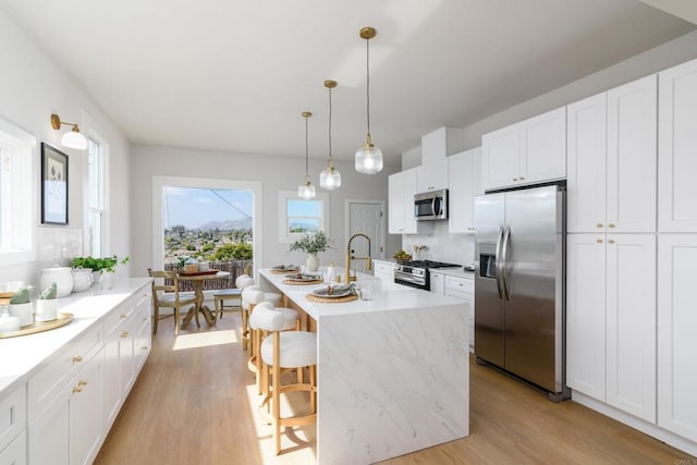 7284 W Point Ave, La Mesa, CA 91942 - kitchen featuring stainless steel appliances, light wood-style flooring, and white cabinets