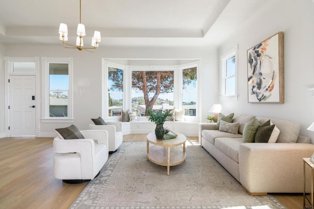 7284 W Point Ave, La Mesa, CA 91942 - living area with wood finished floors, a raised ceiling, and a chandelier