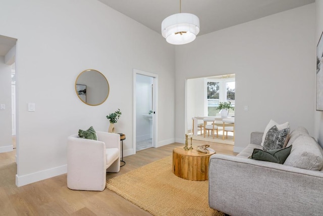 7284 W Point Ave, La Mesa, CA 91942 - living area featuring light wood-type flooring and a towering ceiling