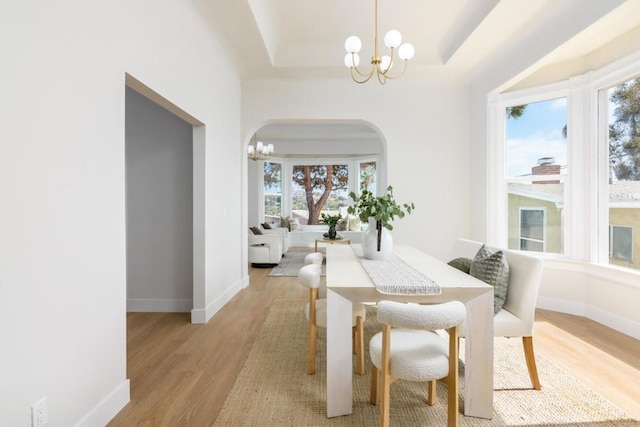 7284 W Point Ave, La Mesa, CA 91942 - dining room featuring a chandelier, light wood-type flooring, and arched walkways