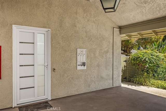 3253 San Amadeo Unit P, Laguna Woods, CA 92637 - property entrance with a patio and stucco siding