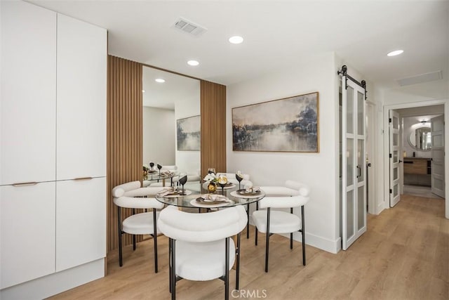 3253 San Amadeo Unit P, Laguna Woods, CA 92637 - dining room with a barn door, light wood finished floors, and recessed lighting