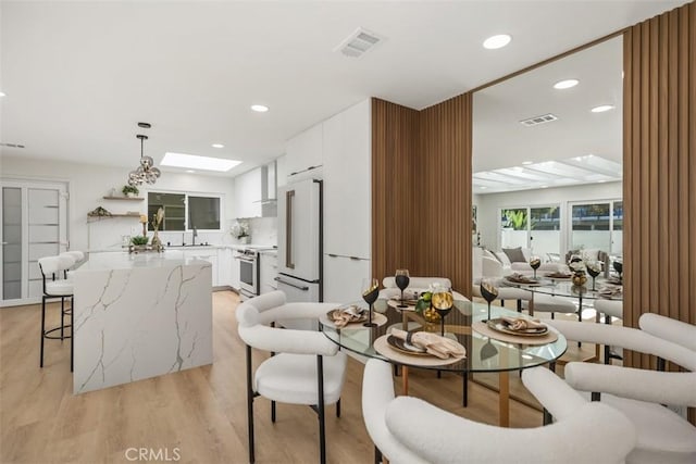 3253 San Amadeo Unit P, Laguna Woods, CA 92637 - dining area with light wood-style floors, recessed lighting, and a skylight
