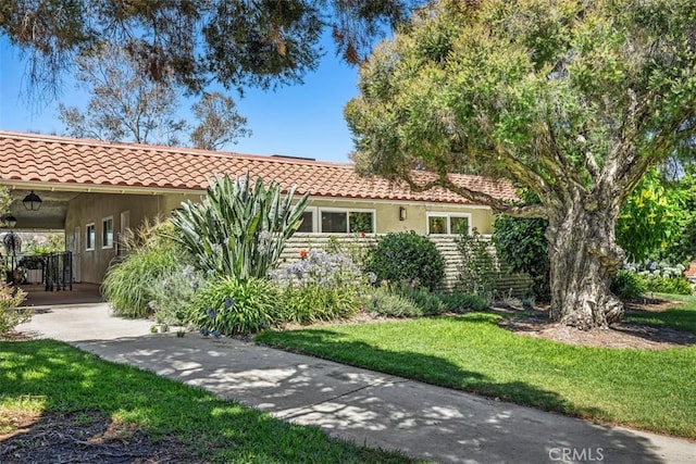 3253 San Amadeo Unit P, Laguna Woods, CA 92637 - mediterranean / spanish house with a tile roof and a front yard
