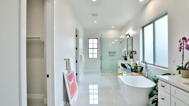 17413 Siena Ln, Fountain Valley, CA 92708 - full bathroom with vanity, a shower stall, a freestanding bath, recessed lighting, and tile patterned flooring