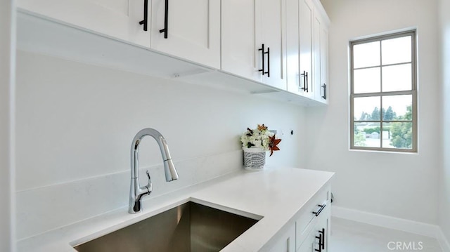 17413 Siena Ln, Fountain Valley, CA 92708 - kitchen featuring white cabinetry and light countertops