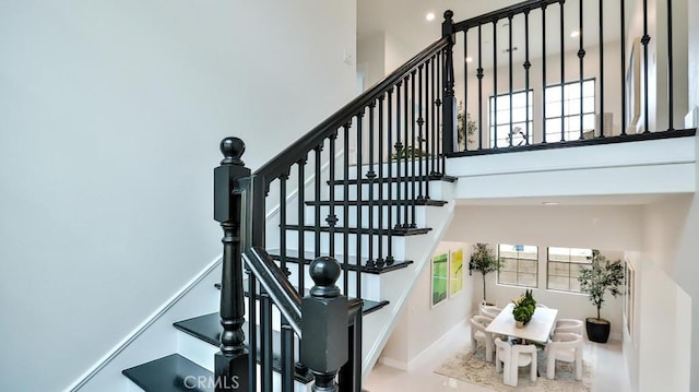 17413 Siena Ln, Fountain Valley, CA 92708 - stairway featuring a high ceiling and baseboards