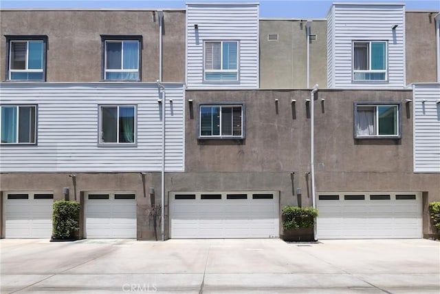 9044 Garvey Ave Unit 21, Rosemead, CA 91770 - back of house with stucco siding, driveway, and an attached garage