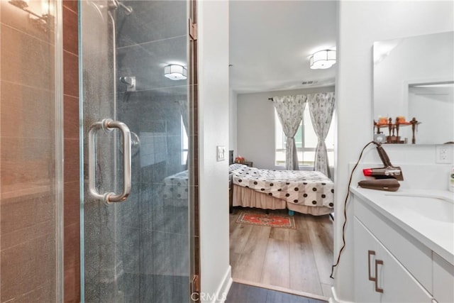 9044 Garvey Ave Unit 21, Rosemead, CA 91770 - ensuite bathroom featuring vanity, a shower stall, and wood finished floors