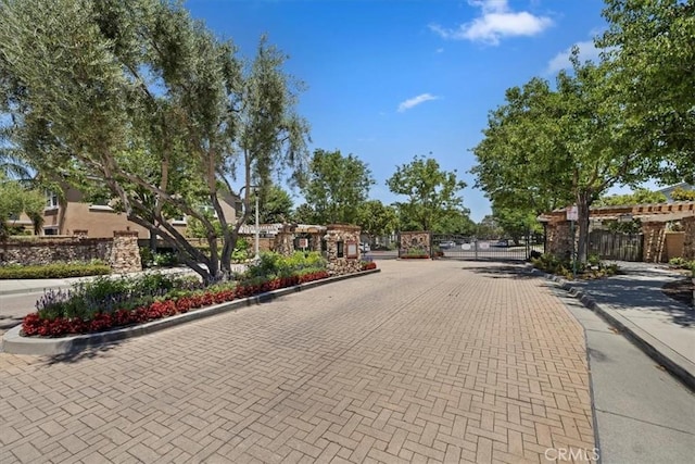 10349 Cooks Dr Unit 2, Rancho Cucamonga, CA 91730 - view of decorative road featuring curbs, a gate, a gated entry, and sidewalks