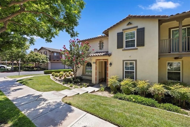 10349 Cooks Dr Unit 2, Rancho Cucamonga, CA 91730 - mediterranean / spanish-style house with stucco siding, a tile roof, a front lawn, and a balcony