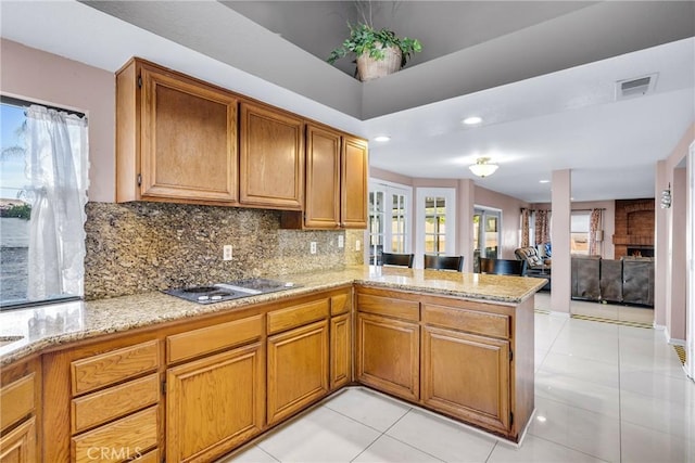 1549 Hillcrest Dr, Pomona, CA 91768 - kitchen with a peninsula, black electric stovetop, decorative backsplash, light stone countertops, and recessed lighting