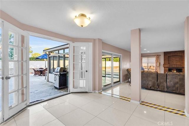 1549 Hillcrest Dr, Pomona, CA 91768 - doorway with french doors, tile patterned floors, and a fireplace