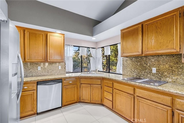 1549 Hillcrest Dr, Pomona, CA 91768 - kitchen with stainless steel appliances, light tile patterned floors, backsplash, brown cabinets, and lofted ceiling