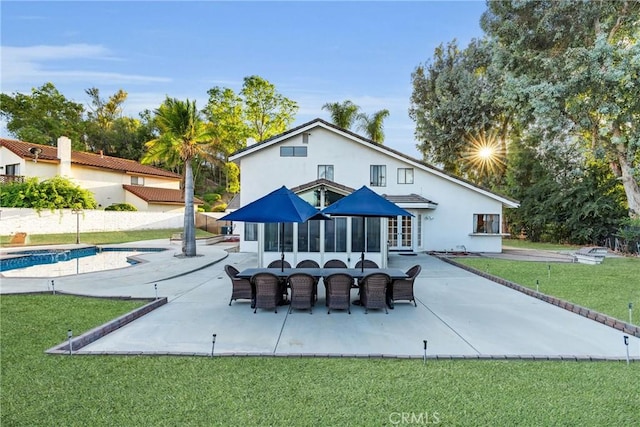 1549 Hillcrest Dr, Pomona, CA 91768 - rear view of house with a patio area, an outdoor pool, a yard, stucco siding, and french doors