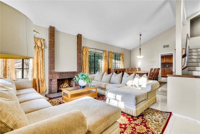 1549 Hillcrest Dr, Pomona, CA 91768 - living room with light tile patterned floors, stairs, high vaulted ceiling, and a brick fireplace