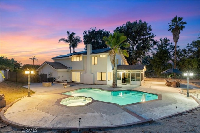 1549 Hillcrest Dr, Pomona, CA 91768 - view of pool with a patio area, a fenced backyard, a sunroom, and a pool with connected hot tub