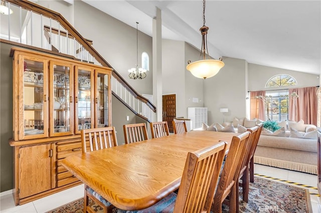1549 Hillcrest Dr, Pomona, CA 91768 - dining space with stairs, light tile patterned floors, a chandelier, and high vaulted ceiling