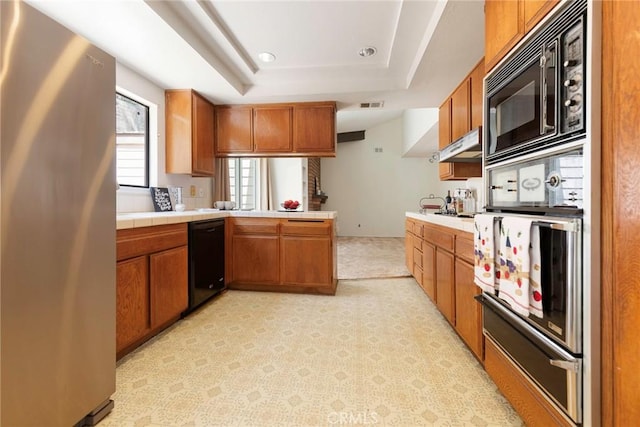 6157 Hillary Ct, Riverside, CA 92506 - kitchen with black appliances, tile counters, brown cabinets, a warming drawer, and recessed lighting