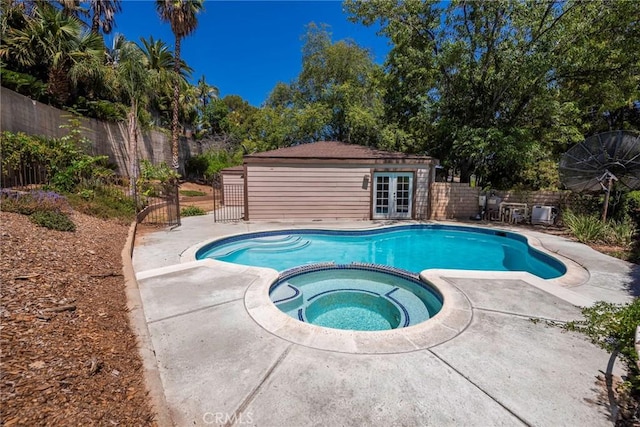 6157 Hillary Ct, Riverside, CA 92506 - view of pool featuring a pool with connected hot tub, french doors, a fenced backyard, and a patio