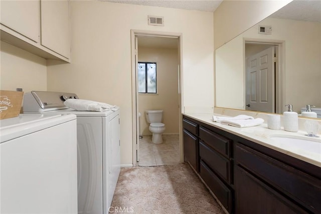 6157 Hillary Ct, Riverside, CA 92506 - washroom with washer and dryer, light tile patterned flooring, and light colored carpet