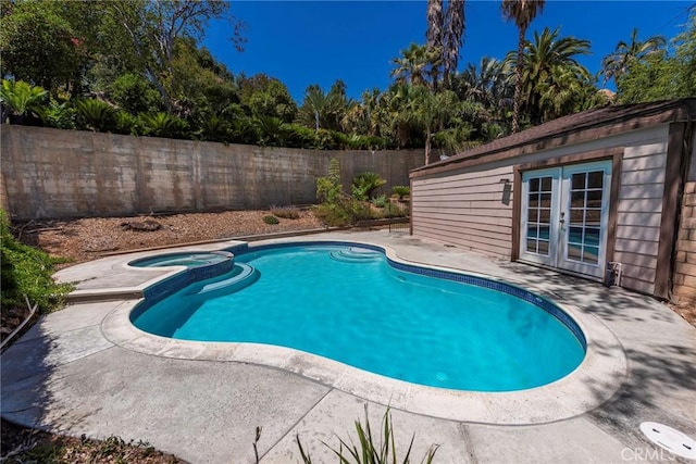 6157 Hillary Ct, Riverside, CA 92506 - view of swimming pool with french doors, a fenced backyard, a patio, and a pool with connected hot tub