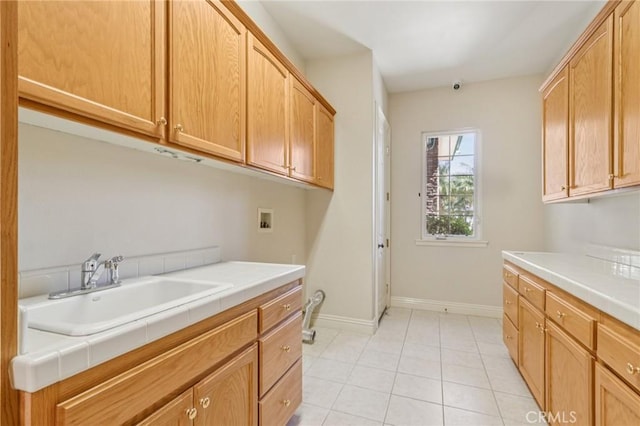 16860 Rayen St, Northridge, CA 91343 - laundry room with cabinet space, hookup for a washing machine, and light tile patterned floors