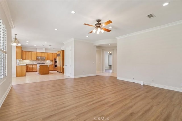 16860 Rayen St, Northridge, CA 91343 - unfurnished living room featuring crown molding, light wood-type flooring, recessed lighting, ceiling fan, and arched walkways
