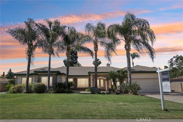 16860 Rayen St, Northridge, CA 91343 - ranch-style home featuring concrete driveway, a garage, and a front lawn