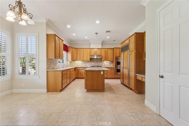 16860 Rayen St, Northridge, CA 91343 - kitchen with backsplash, ornamental molding, a center island, under cabinet range hood, and a chandelier