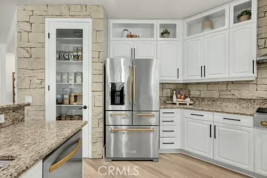 2056 Caltha Way, Perris, CA 92571 - kitchen featuring appliances with stainless steel finishes, open shelves, white cabinets, and light stone countertops
