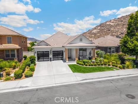 2056 Caltha Way, Perris, CA 92571 - view of front of home with a garage, concrete driveway, and a mountain view