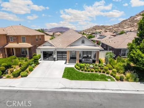 2056 Caltha Way, Perris, CA 92571 - view of front of property with driveway, an attached garage, a mountain view, a residential view, and a tile roof