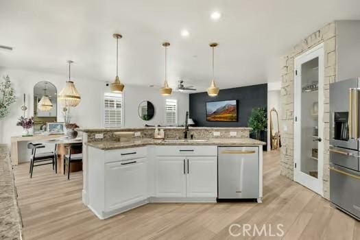 2056 Caltha Way, Perris, CA 92571 - kitchen featuring appliances with stainless steel finishes, light wood-type flooring, white cabinetry, and light stone counters