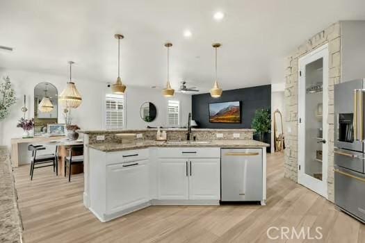 2056 Caltha Way, Perris, CA 92571 - kitchen featuring appliances with stainless steel finishes, light wood-style flooring, white cabinets, light stone countertops, and ceiling fan