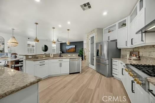 2056 Caltha Way, Perris, CA 92571 - kitchen featuring stainless steel appliances, white cabinetry, light wood-style flooring, glass insert cabinets, and light stone counters