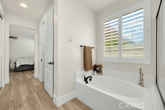 2056 Caltha Way, Perris, CA 92571 - ensuite bathroom featuring a garden tub and wood finished floors