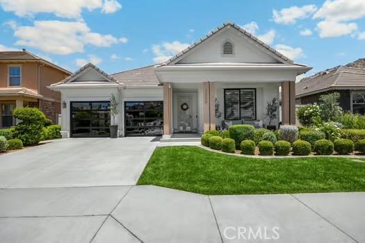 2056 Caltha Way, Perris, CA 92571 - view of front of property with a garage, concrete driveway, a front lawn, and stucco siding