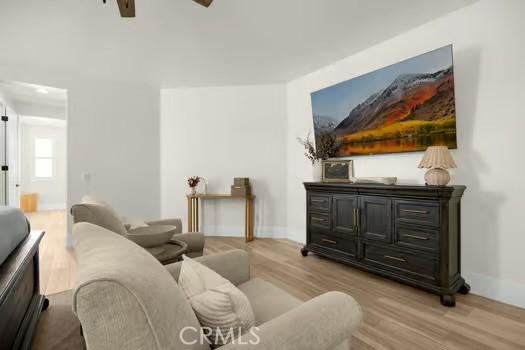 2056 Caltha Way, Perris, CA 92571 - living room with ceiling fan and light wood-style flooring