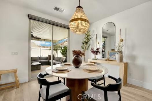 2056 Caltha Way, Perris, CA 92571 - dining room with light wood finished floors and a chandelier
