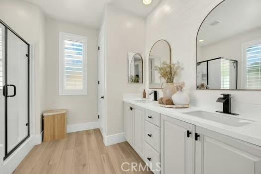 2056 Caltha Way, Perris, CA 92571 - bathroom featuring radiator heating unit, plenty of natural light, a stall shower, and double vanity