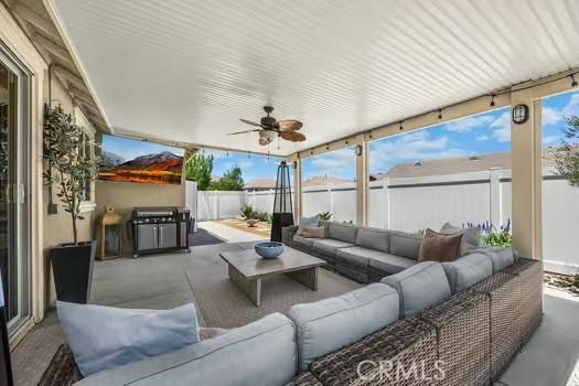 2056 Caltha Way, Perris, CA 92571 - fenced backyard featuring outdoor lounge area, ceiling fan, and a patio area
